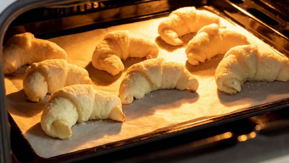 Croissants on a baking sheet in the oven