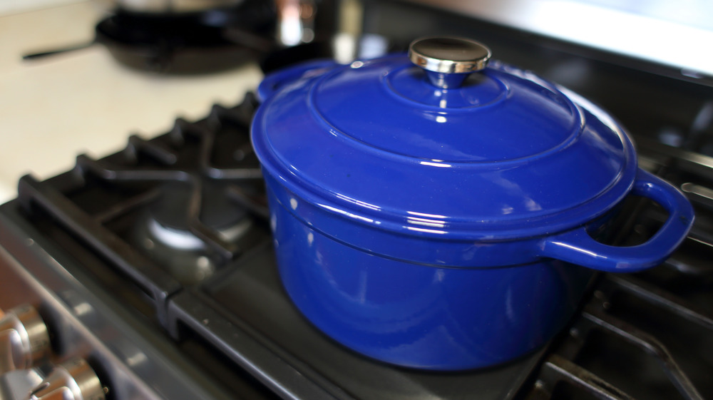 Blue Dutch oven on a black stove top