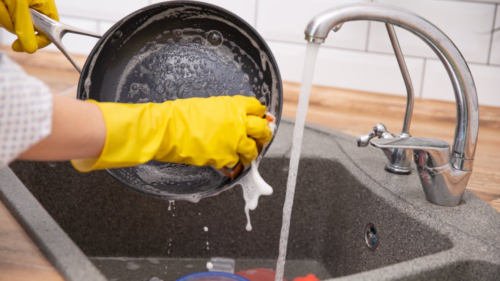 Cleaning a pan in the kitchen sink