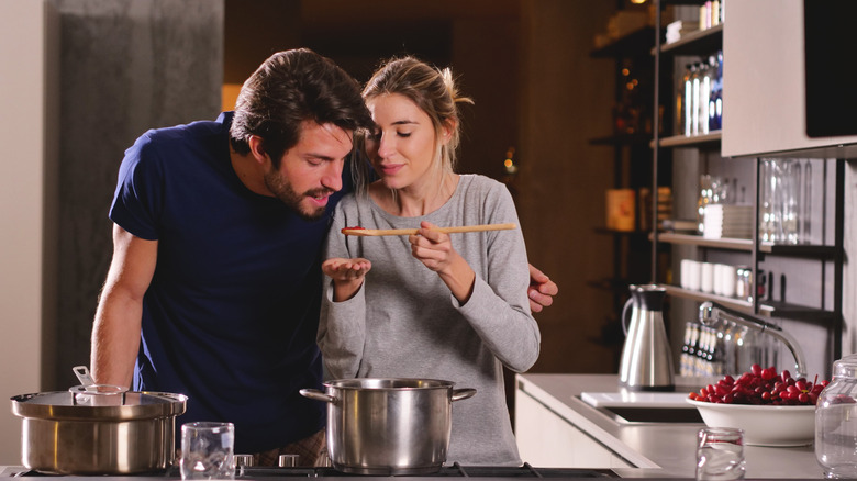 couple tasting sauce