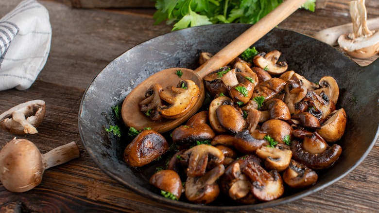 cooked mushrooms in iron skillet