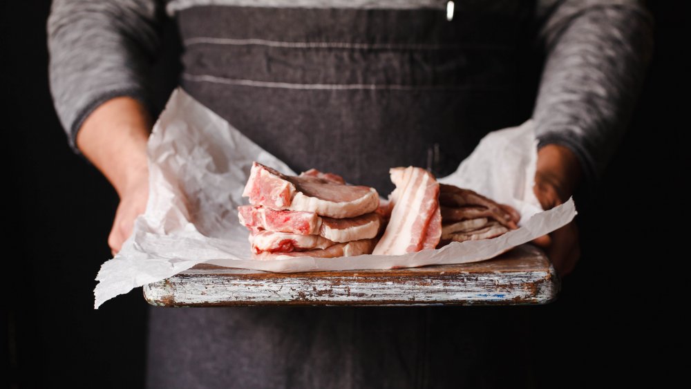 Butcher holding meat