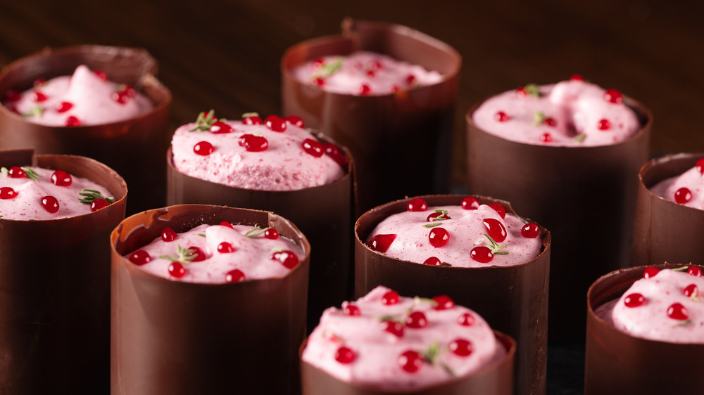 Tempered chocolate collars around pomegranate mousse