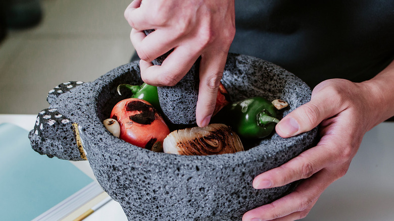 Person using mortar and pestle