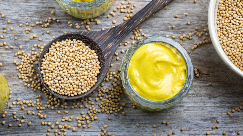 Overhead shot of yellow mustard on wood table