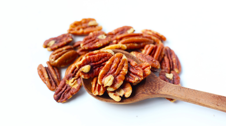 Pecans on a wooden spoon