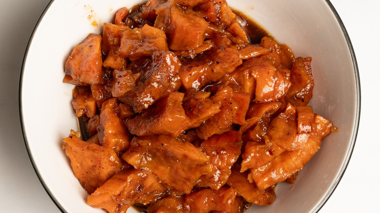 Candied sweet potatoes in a white bowl