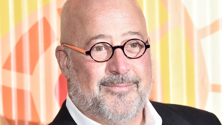 Andrew Zimmern wearing round glasses