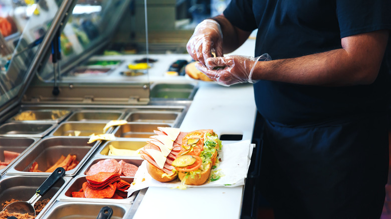 man looking at sandwich display 