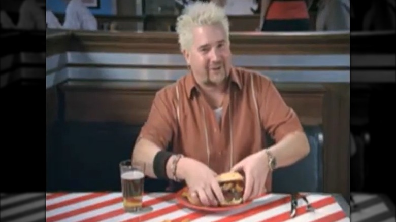 Guy Fieri about to eat a burger at TGI Fridays
