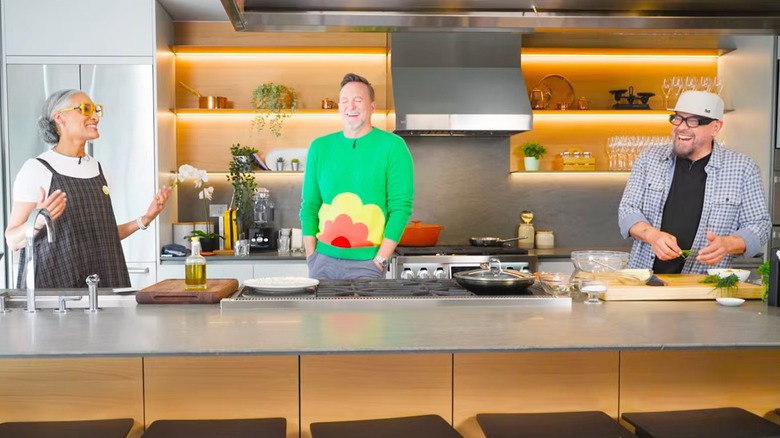 Carla Hall, Clinton Kelly, and Michael Symon in the set/kitchen of "Chewed Up"