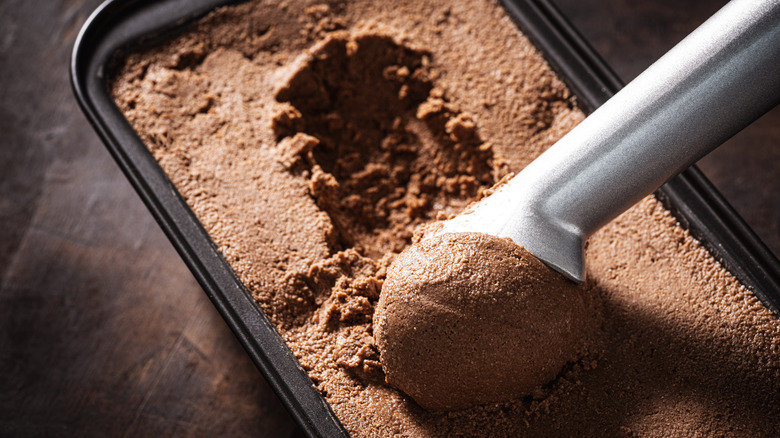 Scooper going into tub of chocolate ice cream
