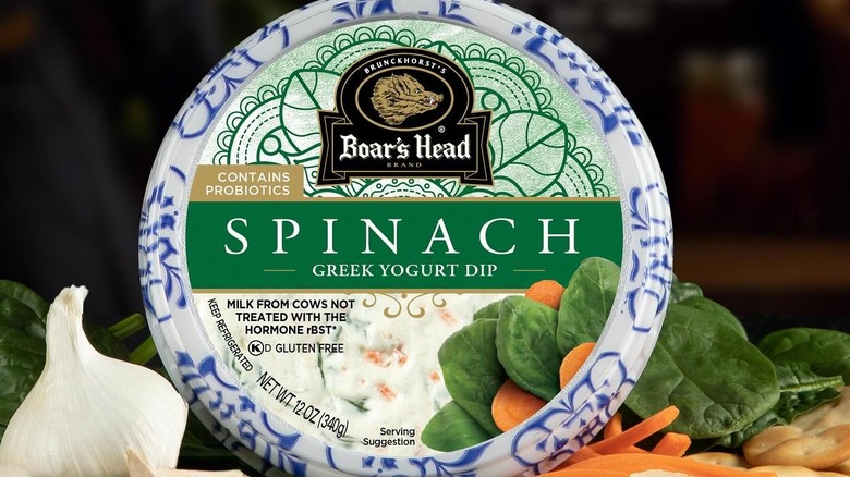 Container of Boar's Head Spinach Greek Yogurt Dip surrounded by ingredients