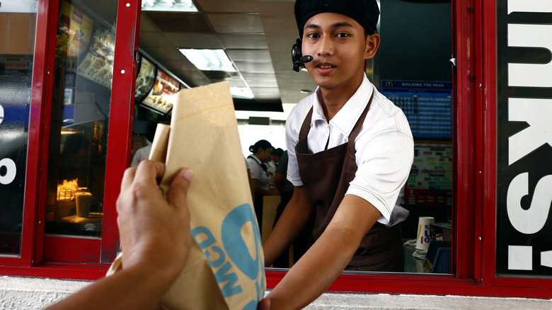 drive-thru worker giving bag