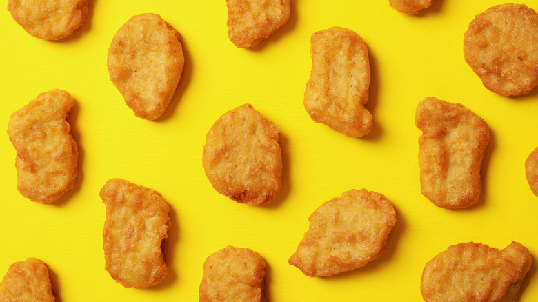 Chicken nuggets scattered on yellow surface