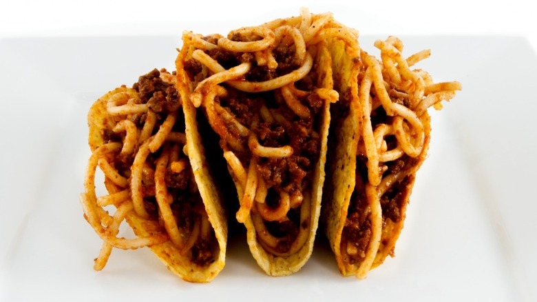 spaghetti tacos on a white plate