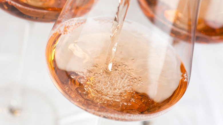 Rosé pouring into glass.