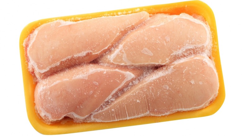 plastic-wrapped frozen chicken breast