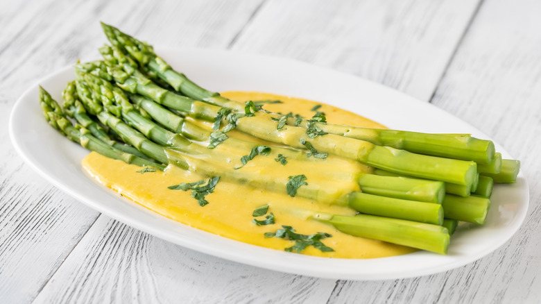 asparagus covered with yellow sauce