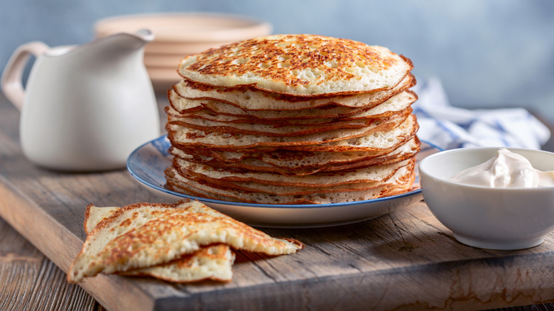 Stack of yeast pancakes on plate.