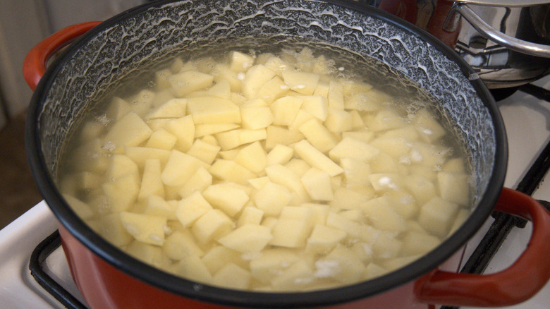 Potato slices in pot of boiling water