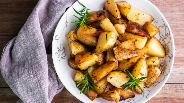Plate of roasted potatoes with herbs