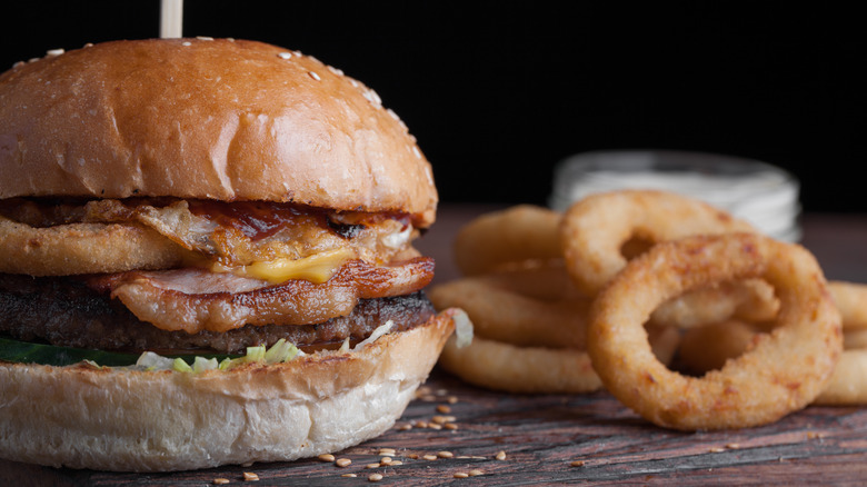 western style burger with onion rings and bacon