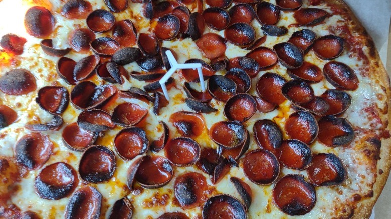 Burnt pepperonis on a pizza