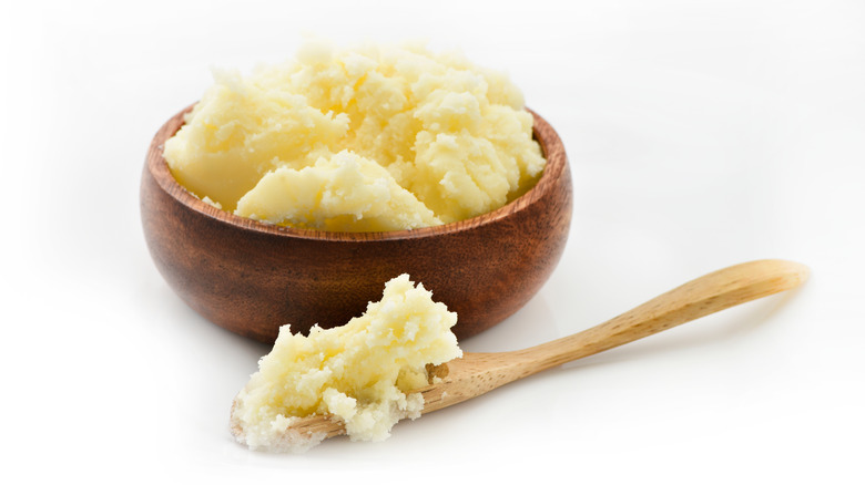 Clarified butter in wood bowl with wood spoon
