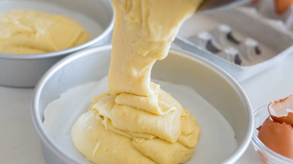 Batter being poured into cake pan