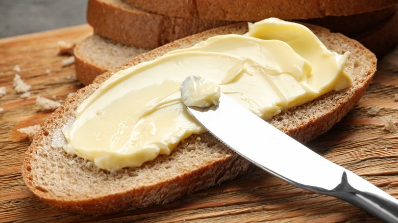 Spreading butter on bread