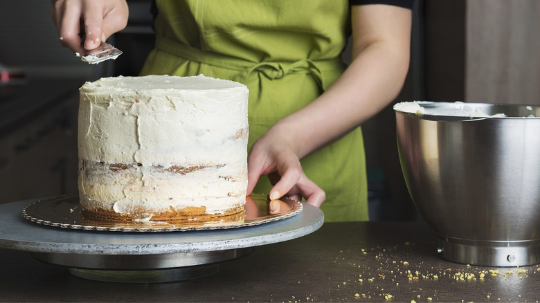 woman frosting cake