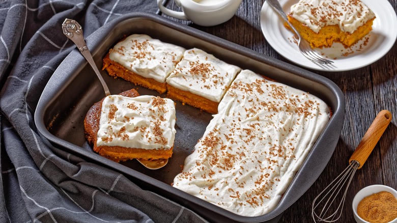 A frosted spice cake being served