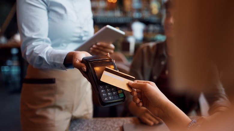Waiter handing credit card payment