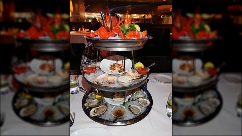 multi tiered chilled shellfish appetizer on table at restaurant