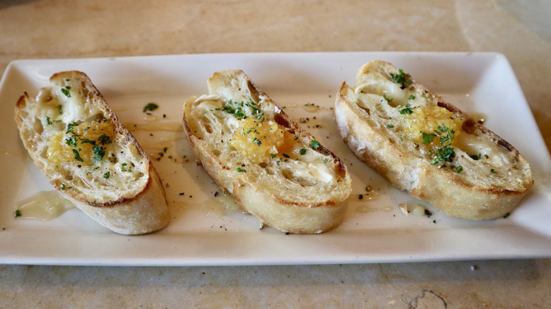 Three pieces of bread with orange jam on top