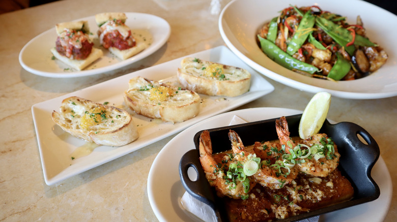 Shrimp and bread dishes on table