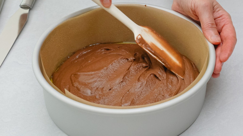 spatula smoothing batter in cake pan