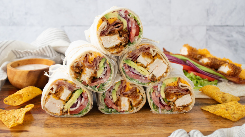 Chicken bacon ranch wraps stacked into a pyramid on wooden board