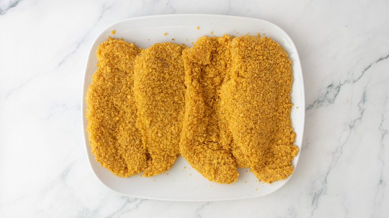Breaded chicken cutlets on plate