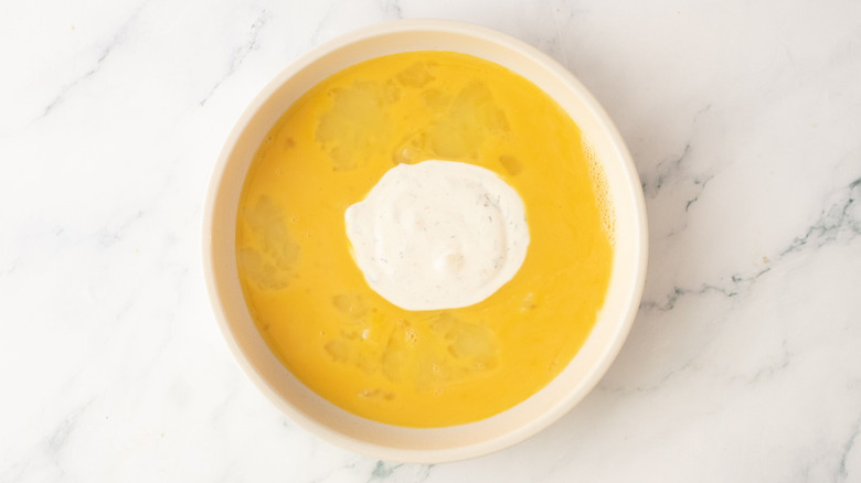 Beaten eggs and ranch in bowl