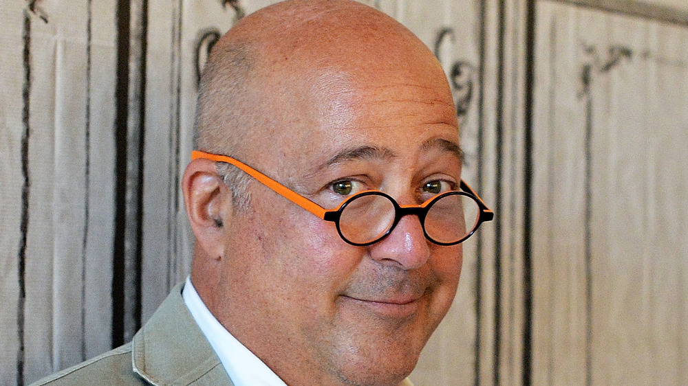 Andrew Zimmern in black and orange glasses