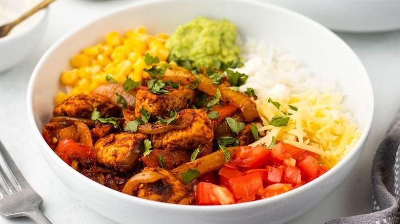 Chicken fajita bowl with various toppings