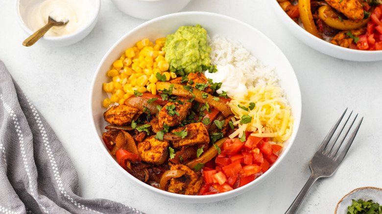Chicken fajita rice bowl with various Mexican-inspired toppings