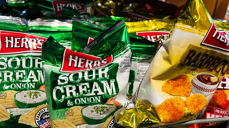 A display shelf of Herr's potato chips in sour cream & onion and barbecue
