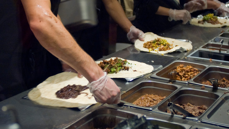 Chipotle employees preparing menu items
