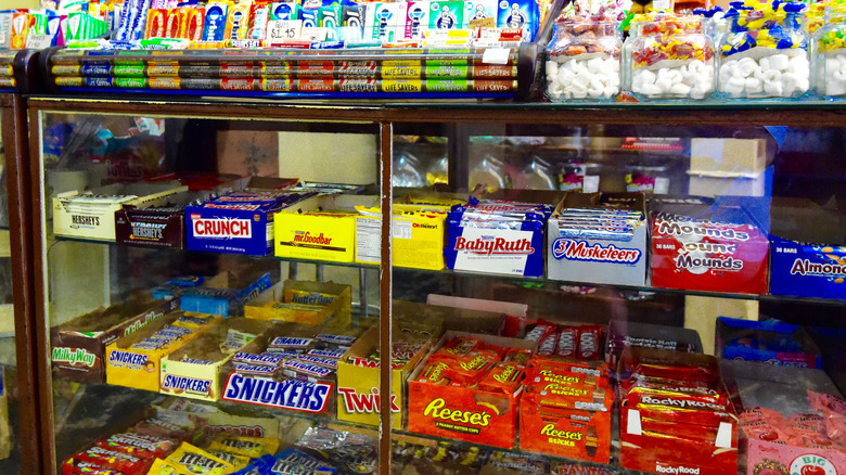 An old glass case lined with classic candy bars.