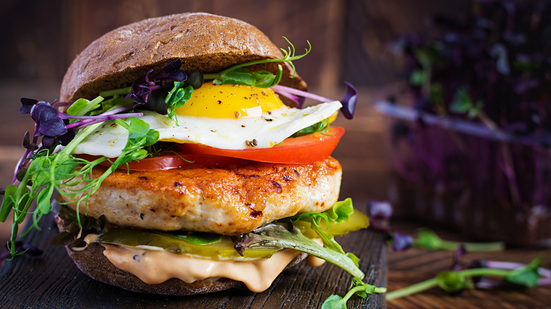 Thick, loaded burger with egg in it