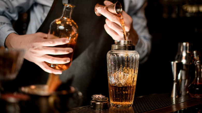 Bartender mixing drink in shaker