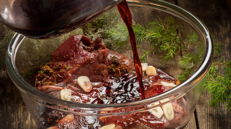 pouring marinade over steak